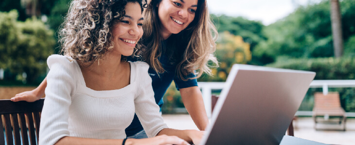 two women smiling looking at a laptop conservatorships and guardianships