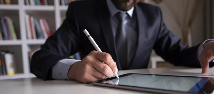 business man writing on a tablet trusts, estate planning, and administration
